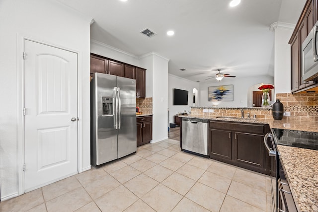 3010 Rosemount Ln, Forney, TX 75126 - kitchen with appliances with stainless steel finishes, a sink, ornamental molding, decorative backsplash, and dark brown cabinets