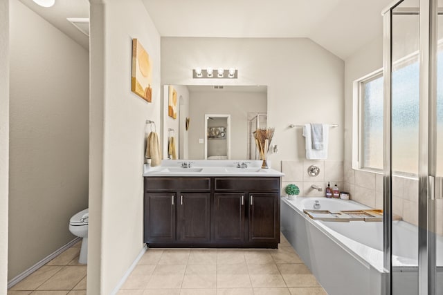 3010 Rosemount Ln, Forney, TX 75126 - bathroom featuring tile patterned floors, a garden tub, toilet, double vanity, and lofted ceiling