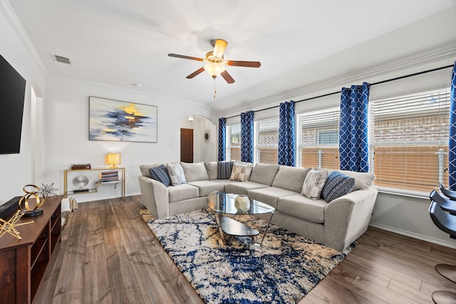 3010 Rosemount Ln, Forney, TX 75126 - living room with arched walkways, ceiling fan, wood finished floors, baseboards, and ornamental molding