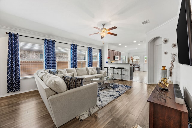 3010 Rosemount Ln, Forney, TX 75126 - living area with ornamental molding, ceiling fan, arched walkways, wood finished floors, and baseboards