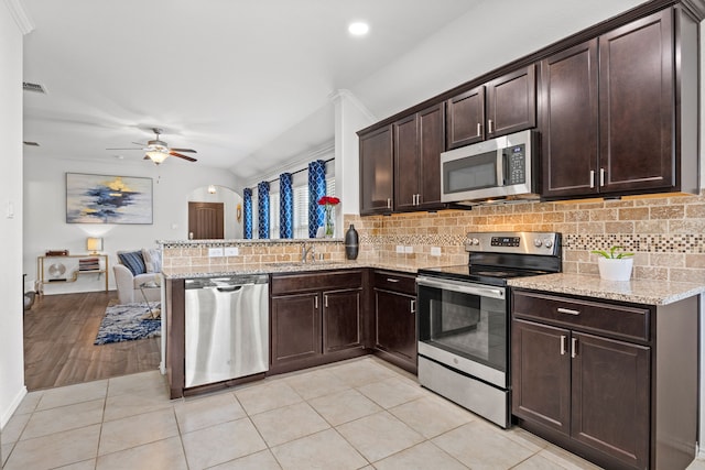 3010 Rosemount Ln, Forney, TX 75126 - kitchen with stainless steel appliances, a sink, tasteful backsplash, open floor plan, and recessed lighting