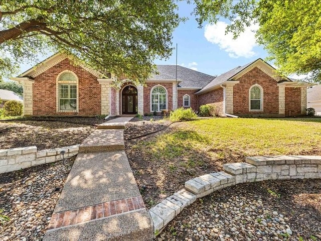 113 Winding Creek Ln, Waco, TX 76657 - view of front of home featuring brick siding, a front lawn, and a shingled roof