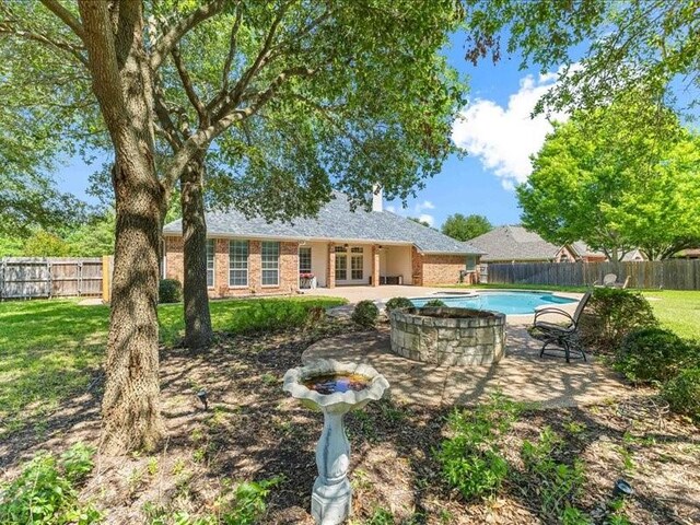 113 Winding Creek Ln, Waco, TX 76657 - rear view of property with french doors, a patio, brick siding, and a chimney