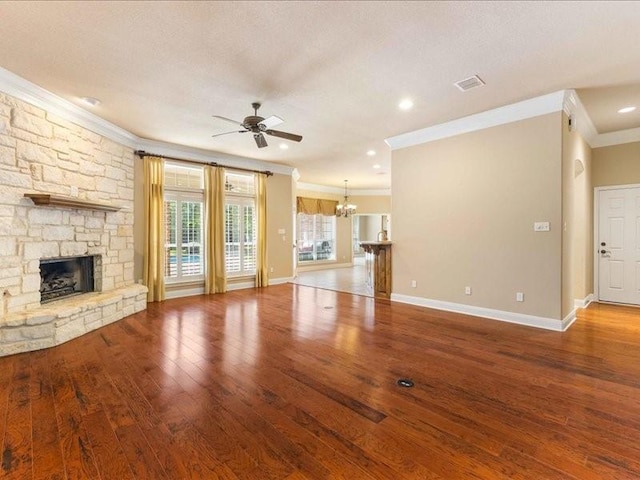 113 Winding Creek Ln, Waco, TX 76657 - unfurnished living room with crown molding, a ceiling fan, a stone fireplace, a chandelier, and wood finished floors