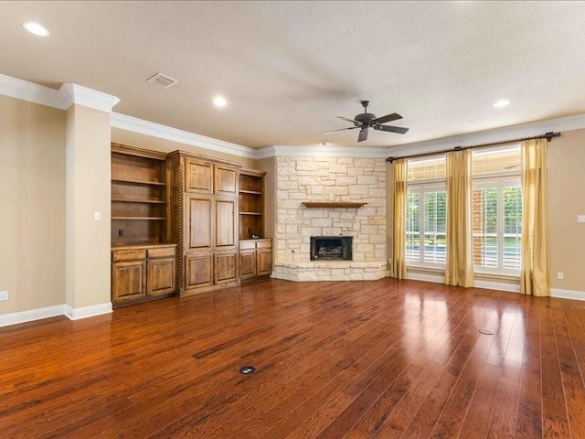 113 Winding Creek Ln, Waco, TX 76657 - unfurnished living room featuring a ceiling fan, crown molding, dark wood-style floors, a fireplace, and baseboards