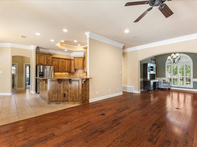 113 Winding Creek Ln, Waco, TX 76657 - unfurnished living room with arched walkways, ornamental molding, light wood-style flooring, a ceiling fan, and recessed lighting