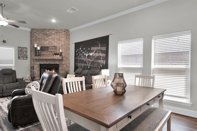 2113 Ajay Dr, Sherman, TX 75092 - dining space featuring a ceiling fan, ornamental molding, dark wood-style flooring, a brick fireplace, and baseboards