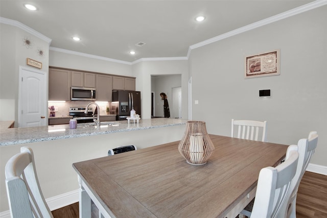 2113 Ajay Dr, Sherman, TX 75092 - dining area featuring dark wood finished floors, recessed lighting, ornamental molding, and baseboards