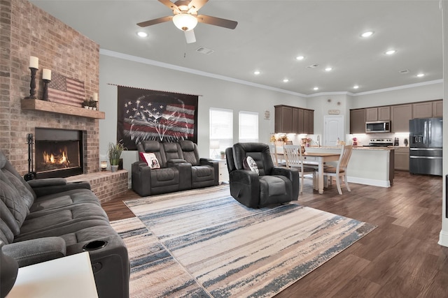 2113 Ajay Dr, Sherman, TX 75092 - living room featuring ceiling fan, dark wood finished floors, recessed lighting, crown molding, and a fireplace