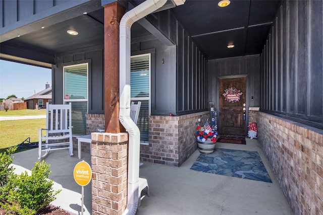2113 Ajay Dr, Sherman, TX 75092 - entrance to property with a porch, board and batten siding, and brick siding