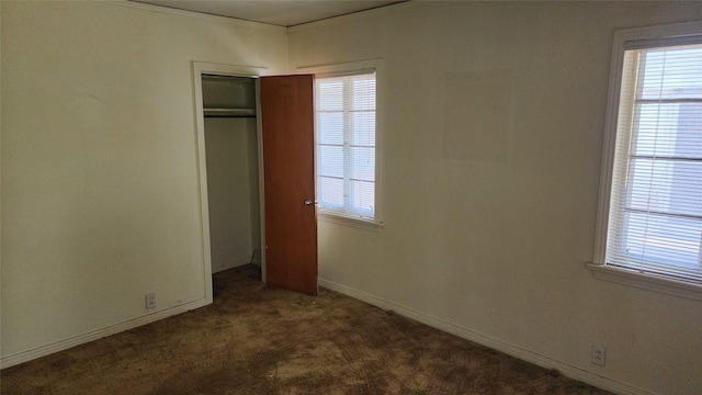 1918 Elmwood Blvd, Dallas, TX 75224 - unfurnished bedroom featuring dark colored carpet, a closet, and baseboards