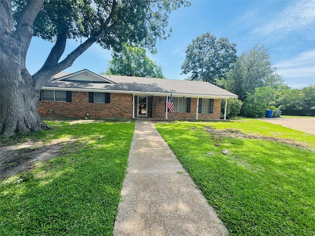 single story home with a front lawn and brick siding