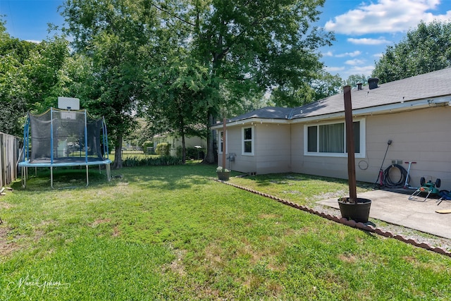 view of yard featuring a trampoline and a patio area