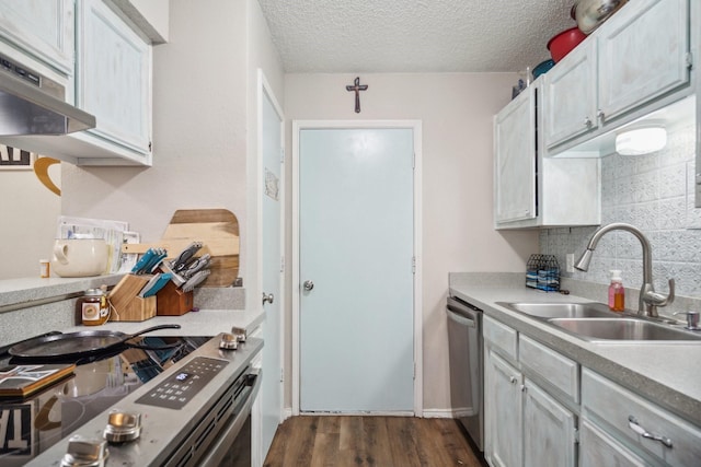816 Red Oak Ct, Azle, TX 76020 - kitchen with a sink, appliances with stainless steel finishes, dark wood-type flooring, light countertops, and under cabinet range hood