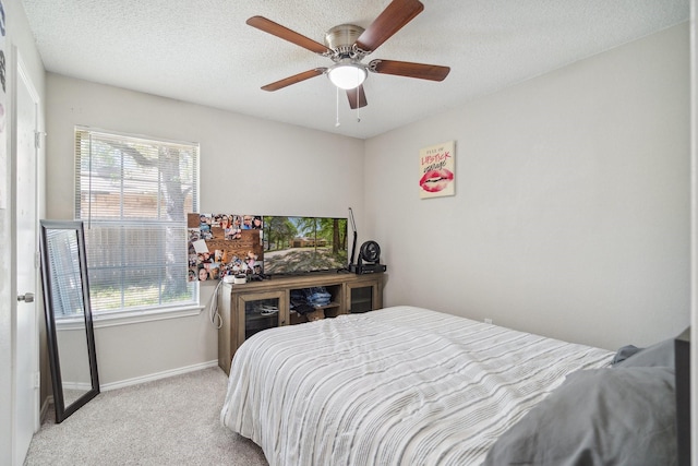 816 Red Oak Ct, Azle, TX 76020 - bedroom with carpet, multiple windows, baseboards, ceiling fan, and a textured ceiling