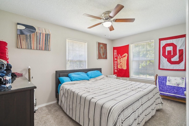 816 Red Oak Ct, Azle, TX 76020 - bedroom with light colored carpet, ceiling fan, baseboards, and a textured ceiling