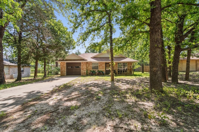 816 Red Oak Ct, Azle, TX 76020 - view of front of home featuring a garage, driveway, brick siding, fence, and covered porch