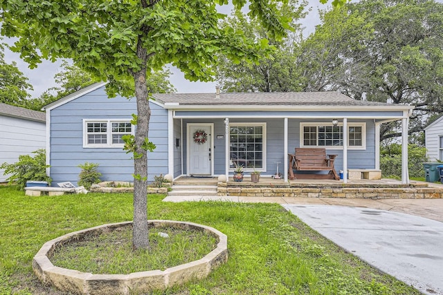 bungalow-style house with covered porch and a front lawn