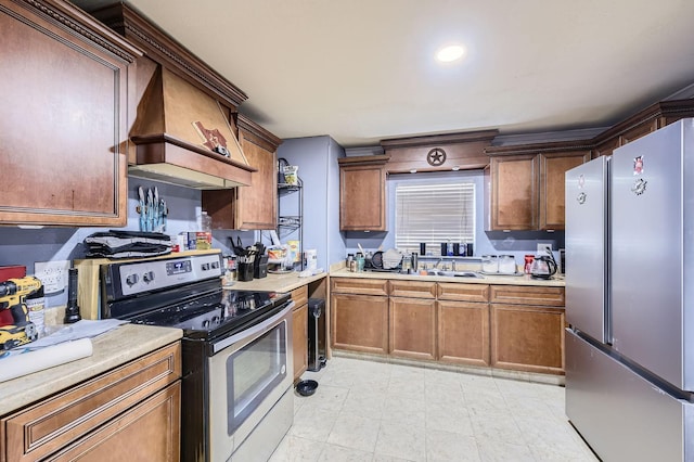 kitchen featuring appliances with stainless steel finishes, premium range hood, light countertops, and brown cabinets