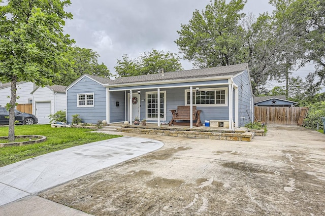 ranch-style home with covered porch and fence