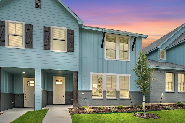 9553 Thorncrown Ln, Fort Worth, TX 76179 - view of front of home with board and batten siding and a lawn