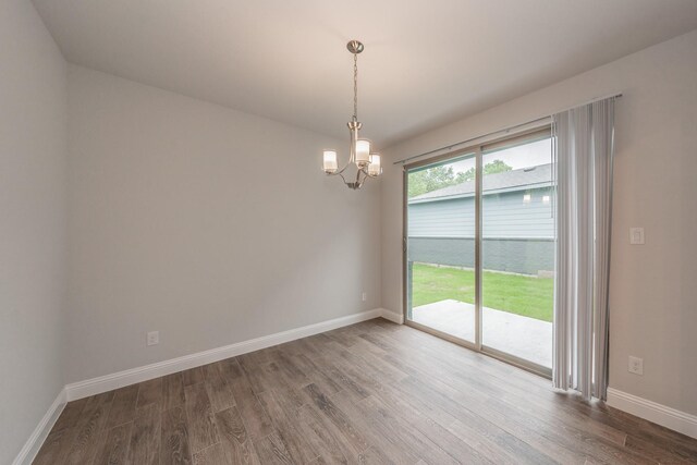 9553 Thorncrown Ln, Fort Worth, TX 76179 - empty room with wood finished floors, a chandelier, and baseboards