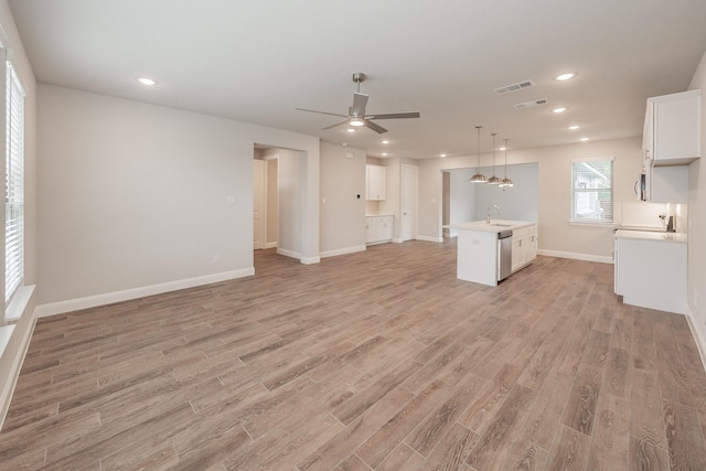 9553 Thorncrown Ln, Fort Worth, TX 76179 - unfurnished living room with a sink, light wood-style floors, ceiling fan, baseboards, and recessed lighting