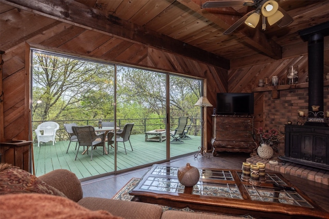 1867 Chaparral Dr, Gainesville, TX 76240 - living area with a wood stove, wood ceiling, ceiling fan, hardwood / wood-style flooring, and wooden walls