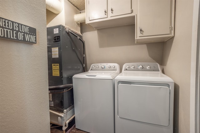 1867 Chaparral Dr, Gainesville, TX 76240 - laundry room with washer and clothes dryer, cabinet space, and a textured wall