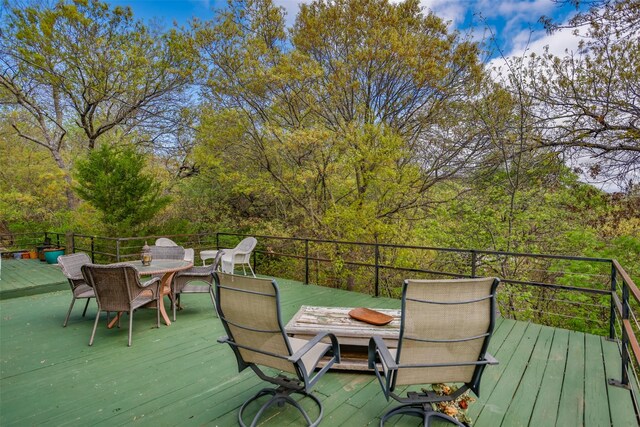 1867 Chaparral Dr, Gainesville, TX 76240 - wooden deck featuring outdoor dining area
