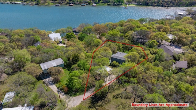 1867 Chaparral Dr, Gainesville, TX 76240 - aerial view of property and surrounding area featuring a nearby body of water and property parcel outlined