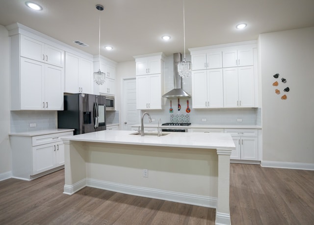 4569 Wilbarger St, Plano, TX 75024 - kitchen featuring wall chimney range hood, appliances with stainless steel finishes, a sink, backsplash, and dark wood-style floors