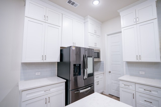 4569 Wilbarger St, Plano, TX 75024 - kitchen featuring appliances with stainless steel finishes, tasteful backsplash, white cabinets, and recessed lighting