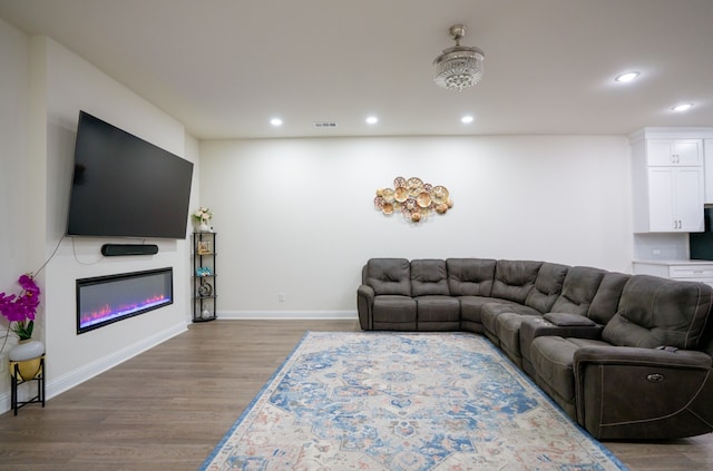 4569 Wilbarger St, Plano, TX 75024 - living area with wood finished floors, recessed lighting, baseboards, and a glass covered fireplace