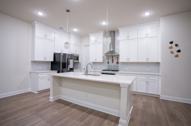 4569 Wilbarger St, Plano, TX 75024 - kitchen featuring appliances with stainless steel finishes, wall chimney range hood, a sink, dark wood-style flooring, and light countertops