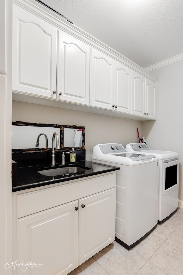 2228 Grapevine Ln, Haughton, LA 71037 - laundry room featuring washing machine and dryer, cabinet space, ornamental molding, and light tile patterned floors