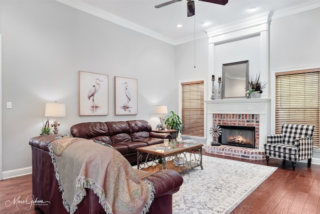 2228 Grapevine Ln, Haughton, LA 71037 - living room featuring a ceiling fan, baseboards, wood finished floors, a fireplace, and crown molding