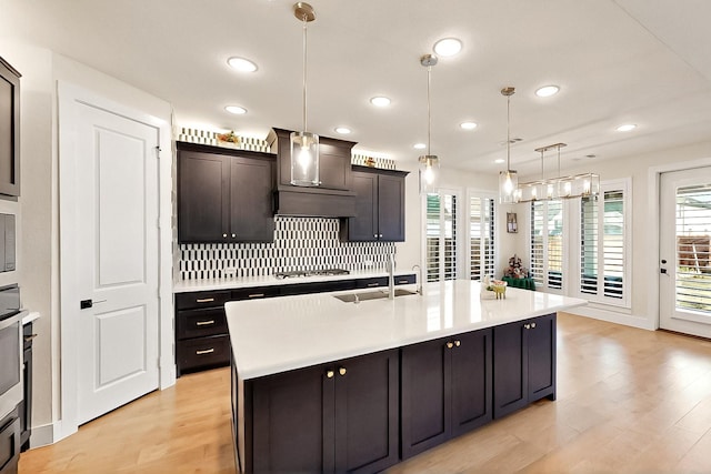 3932 Linear, Celina, TX 75078 - kitchen with custom range hood, gas cooktop, a sink, plenty of natural light, and recessed lighting