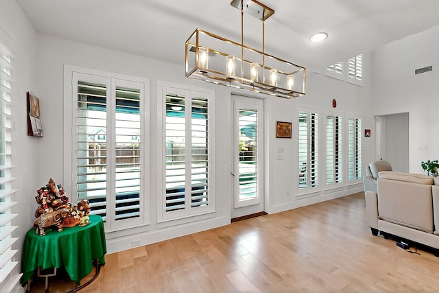 3932 Linear, Celina, TX 75078 - doorway with a chandelier, wood finished floors, and recessed lighting