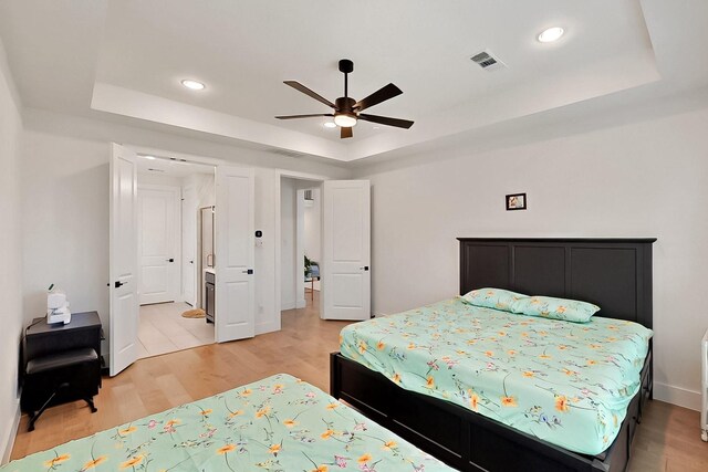 3932 Linear, Celina, TX 75078 - bedroom with a tray ceiling, light wood-style flooring, recessed lighting, and ceiling fan