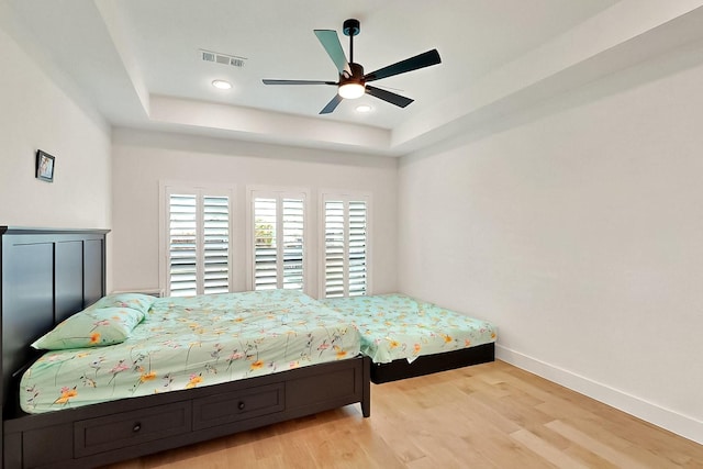 3932 Linear, Celina, TX 75078 - bedroom featuring a tray ceiling, baseboards, wood finished floors, a ceiling fan, and recessed lighting