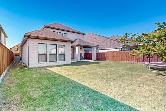 3932 Linear, Celina, TX 75078 - rear view of house with a shingled roof, a trampoline, and brick siding