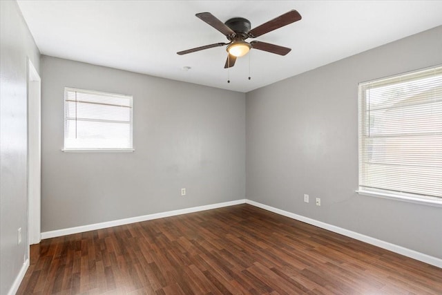 empty room featuring wood finished floors, a ceiling fan, and baseboards
