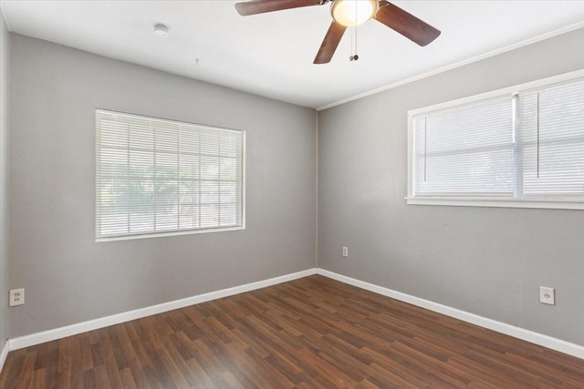 empty room featuring wood finished floors, baseboards, and ceiling fan