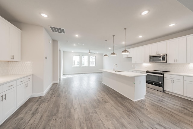 9709 Thorncrown Ln, Fort Worth, TX 76179 - kitchen with appliances with stainless steel finishes, backsplash, light wood-type flooring, open floor plan, and recessed lighting