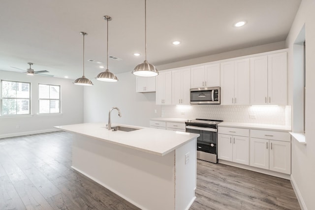 9709 Thorncrown Ln, Fort Worth, TX 76179 - kitchen with appliances with stainless steel finishes, a sink, backsplash, white cabinets, and recessed lighting