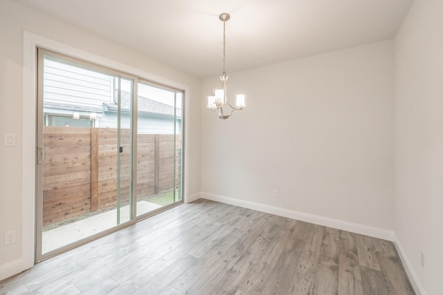 9709 Thorncrown Ln, Fort Worth, TX 76179 - spare room with a chandelier, light wood finished floors, and baseboards