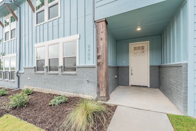 9709 Thorncrown Ln, Fort Worth, TX 76179 - doorway to property with board and batten siding and brick siding