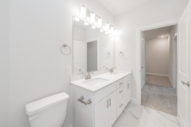 9709 Thorncrown Ln, Fort Worth, TX 76179 - bathroom featuring marble look tiles, toilet, double vanity, and baseboards
