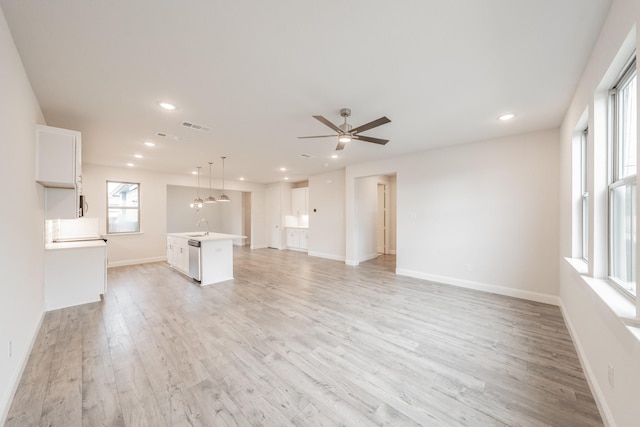 9709 Thorncrown Ln, Fort Worth, TX 76179 - unfurnished living room featuring light wood finished floors, a sink, baseboards, recessed lighting, and a ceiling fan